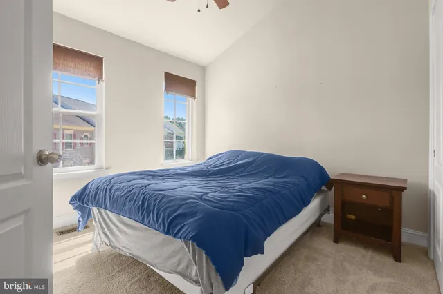 a spacious bedroom with a bed and a window