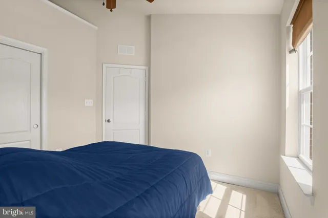 a view of bedroom with a bed and a window