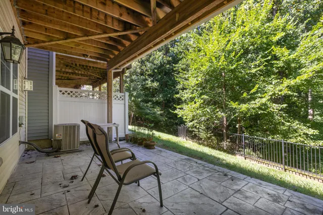a patio with yard glass top table and chairs