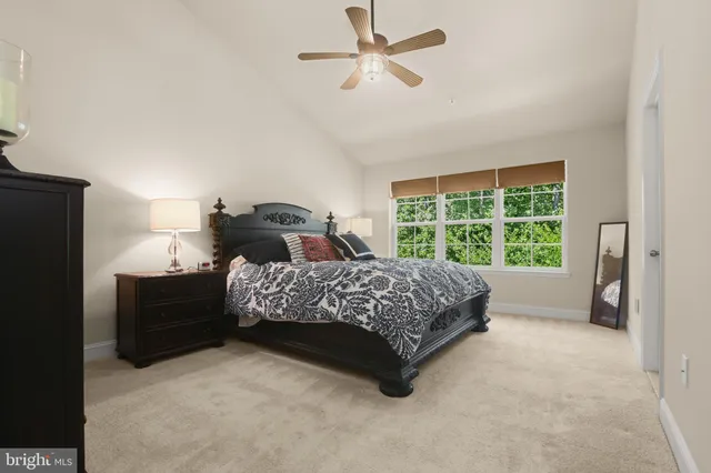 a bedroom with a bed dresser and a window