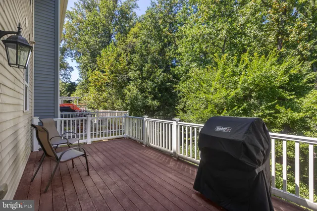 a view of balcony with wooden floor and outdoor seating