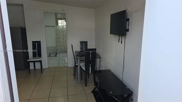 a view of a hallway with workspace and living room area