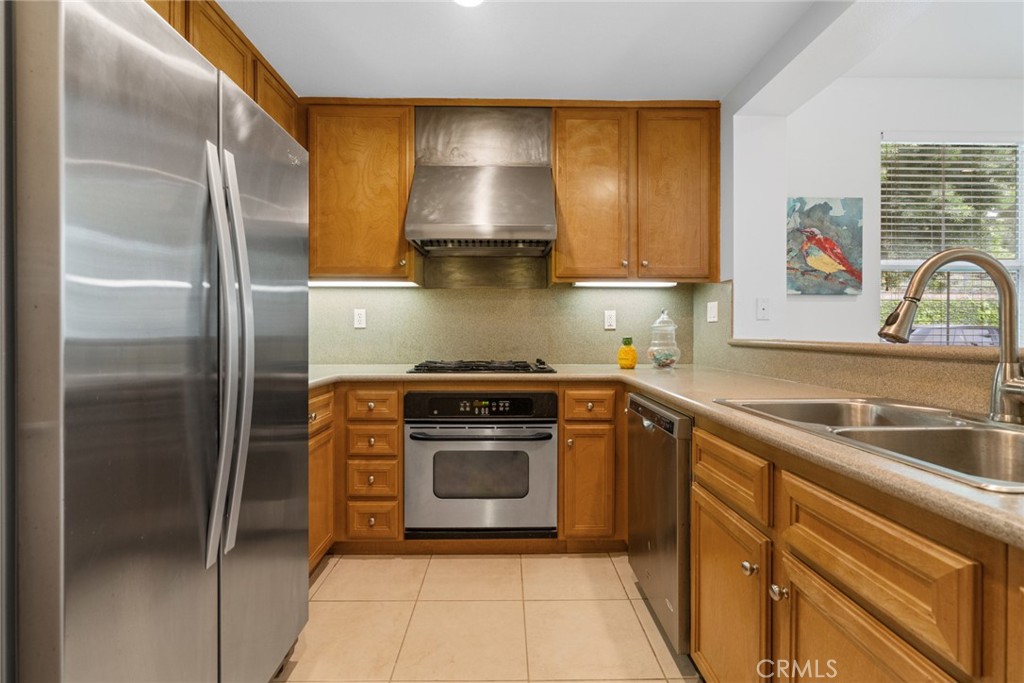 233 Danbrook Irvine, CA 92603 - Photo 17 of 32 a kitchen with a sink cabinets and stainless steel appliances