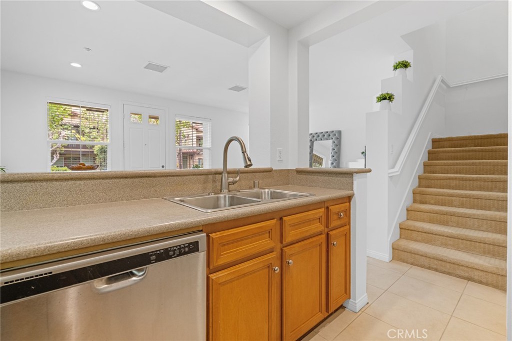 233 Danbrook Irvine, CA 92603 - Photo 18 of 32 a kitchen with a sink and a refrigerator
