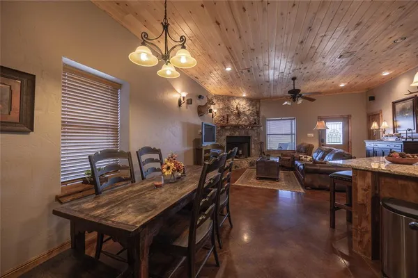 a living room with lots of furniture and kitchen view