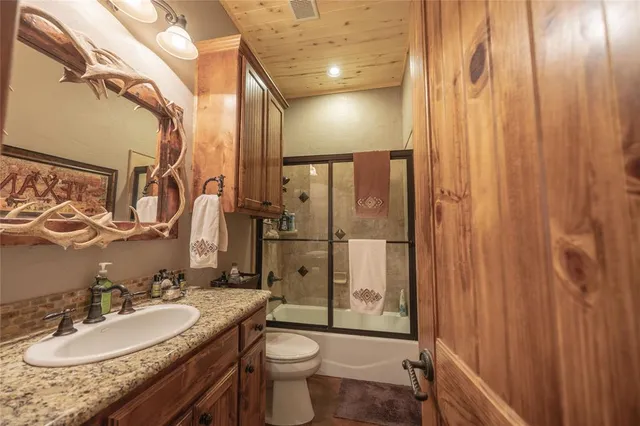 a spacious bedroom with a bed a chandelier and a window