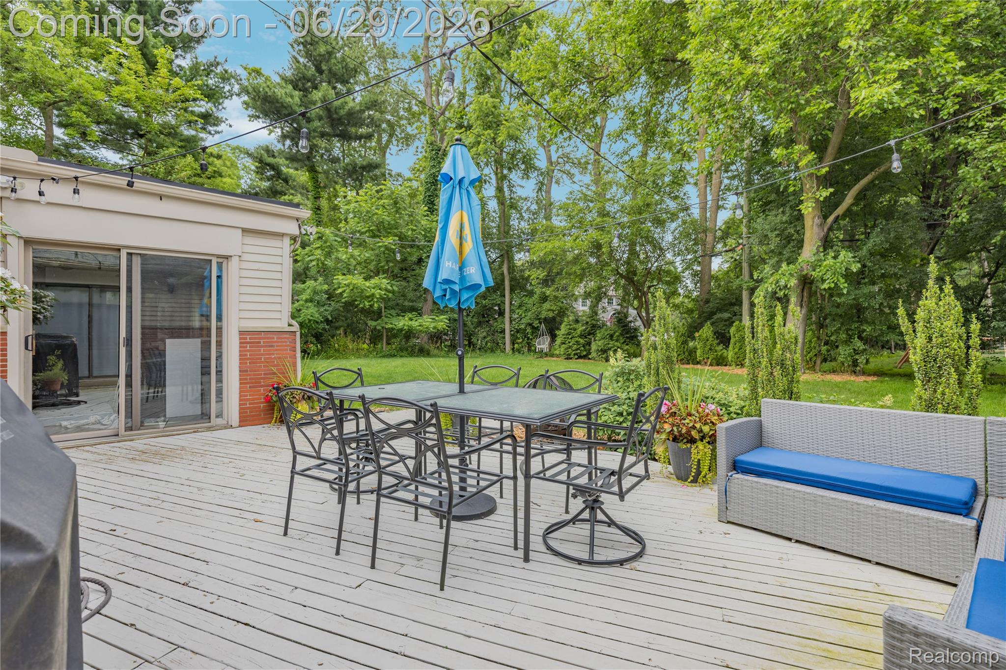 6085 Worlington Road Bloomfield Hills, MI 48301 - Photo 59 of 75 Spacious wood-finish deck with multiple seating areas and string lighting