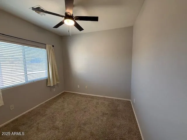 a view of room with window and ceiling fan