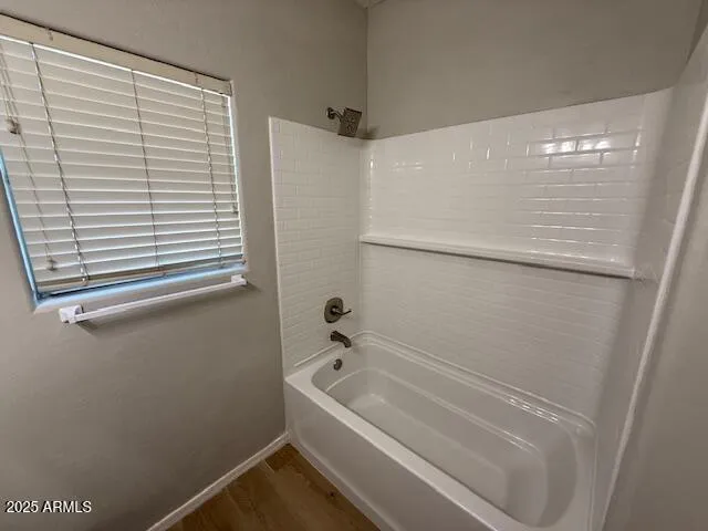 a bathroom with a tub and a shower