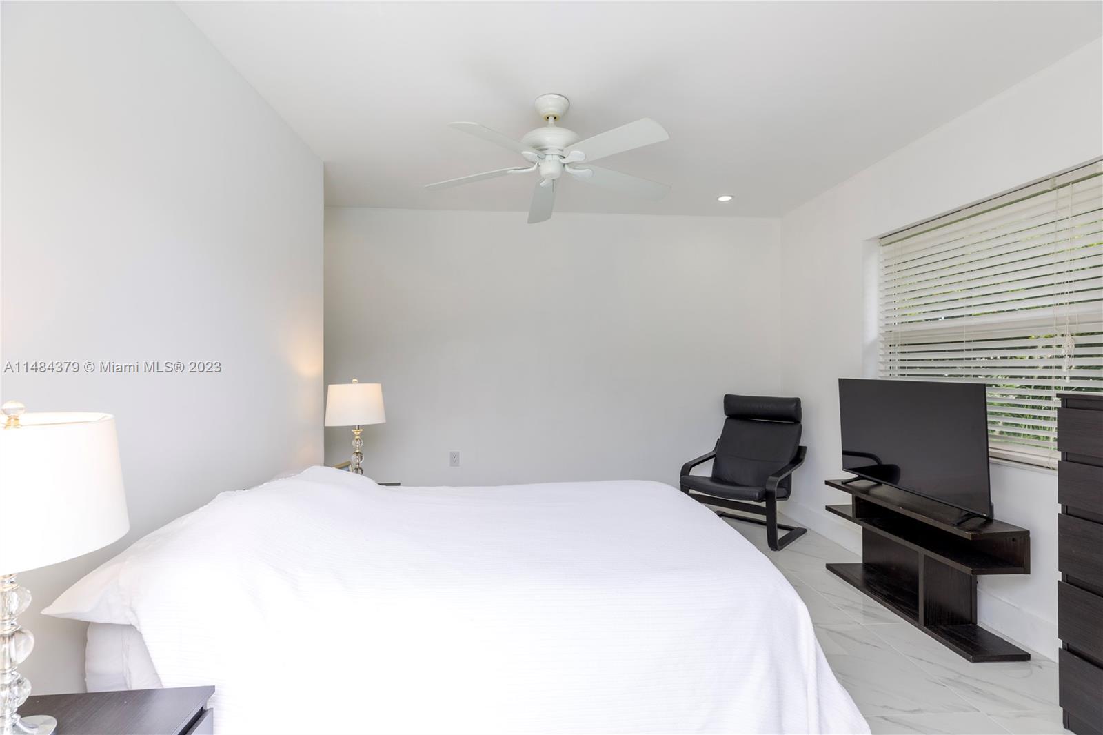 1990 Keystone Boulevard North Miami, FL 33181 - Photo 12 of 20 a bedroom with a bed and a tv