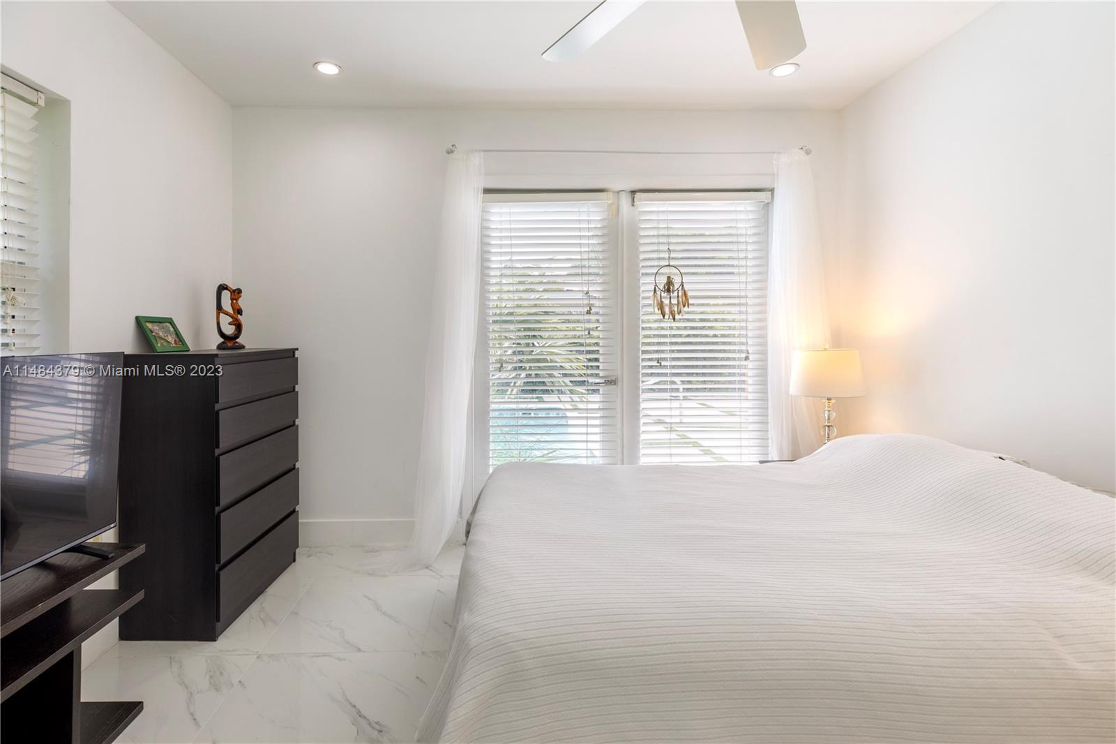 1990 Keystone Boulevard North Miami, FL 33181 - Photo 13 of 20 a bedroom with a bed and a flat screen tv