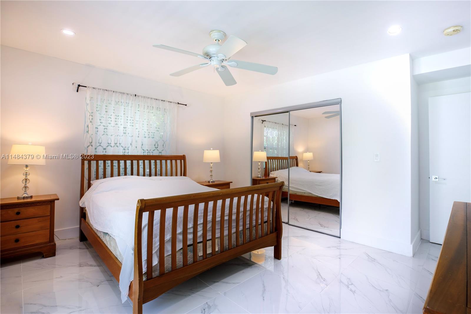 1990 Keystone Boulevard North Miami, FL 33181 - Photo 15 of 20 a bed room with a bed and a chandelier