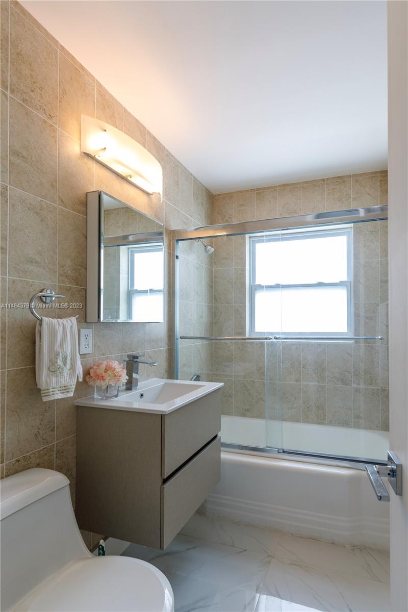 1990 Keystone Boulevard North Miami, FL 33181 - Photo 17 of 20 a bathroom with a sink a toilet and shower