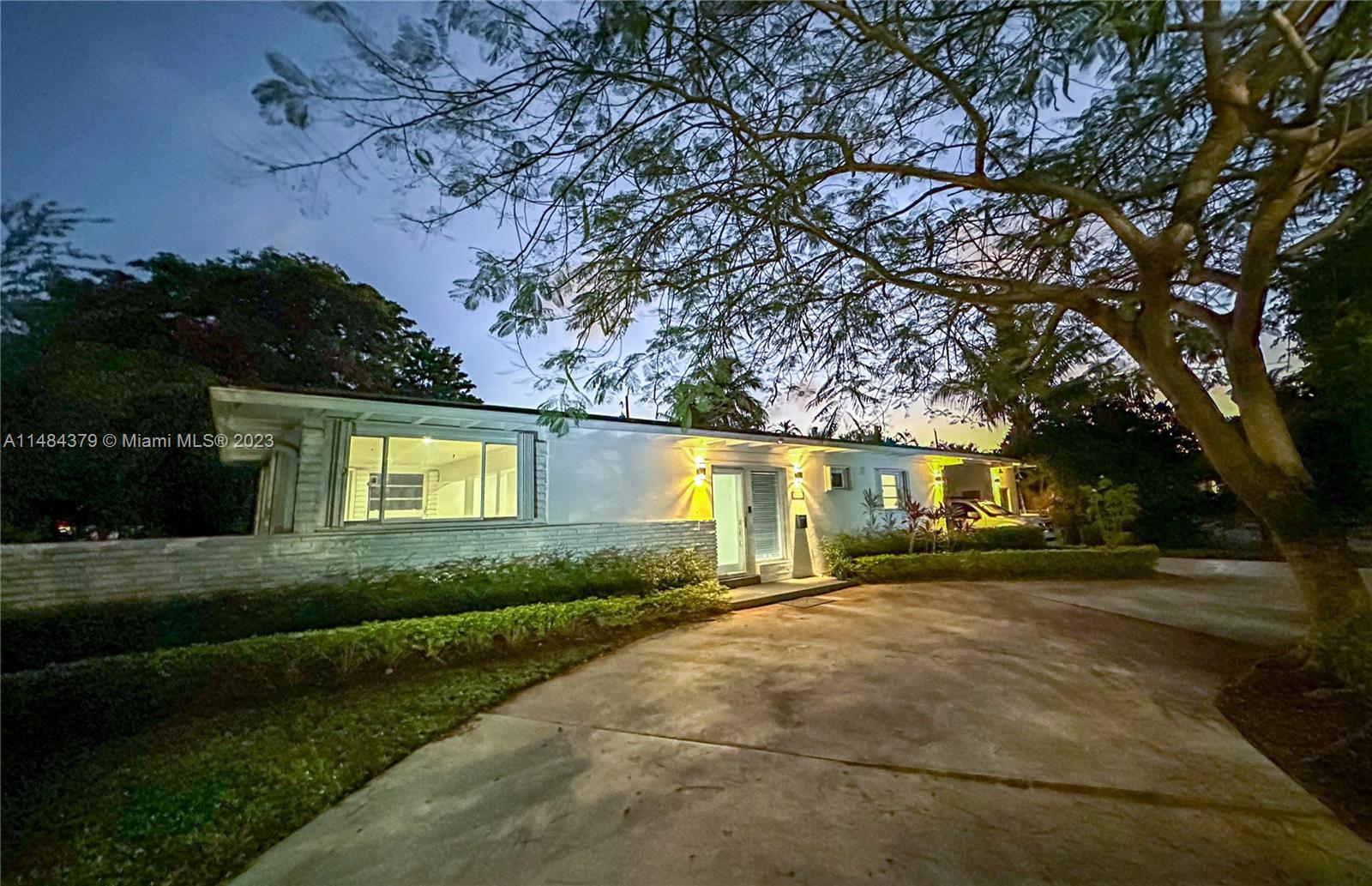 1990 Keystone Boulevard North Miami, FL 33181 - Photo 19 of 20 a front view of a house with a yard and garage
