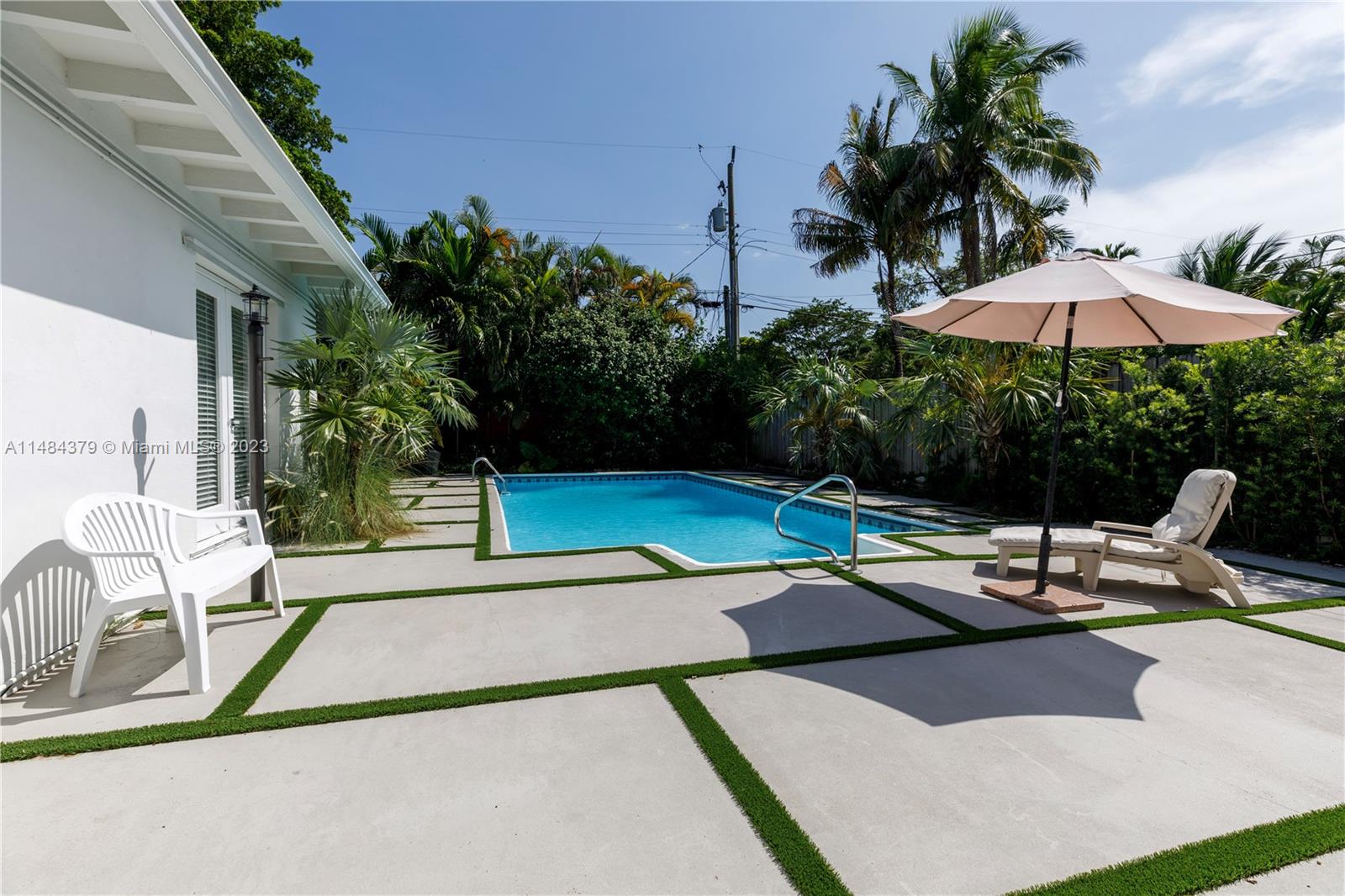 1990 Keystone Boulevard North Miami, FL 33181 - Photo 2 of 20 a view of a patio with swimming pool table and chairs
