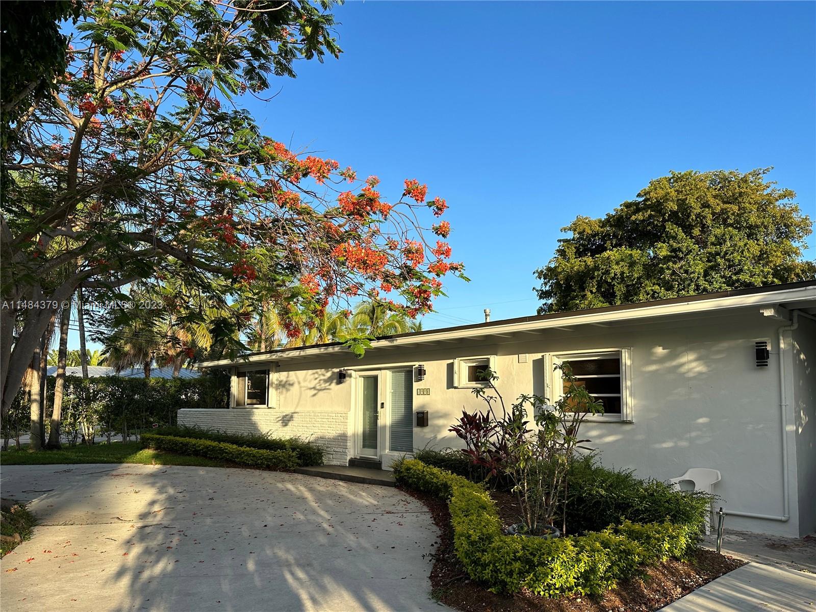 1990 Keystone Boulevard North Miami, FL 33181 - Photo 3 of 20 a front view of a house with garden