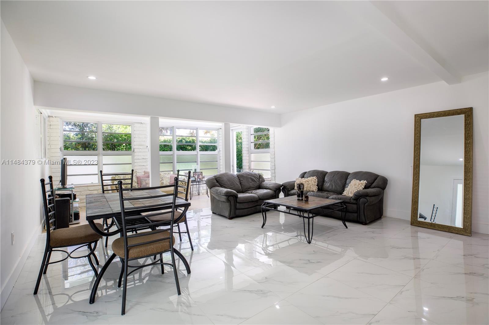 1990 Keystone Boulevard North Miami, FL 33181 - Photo 5 of 20 a living room with furniture and a large window