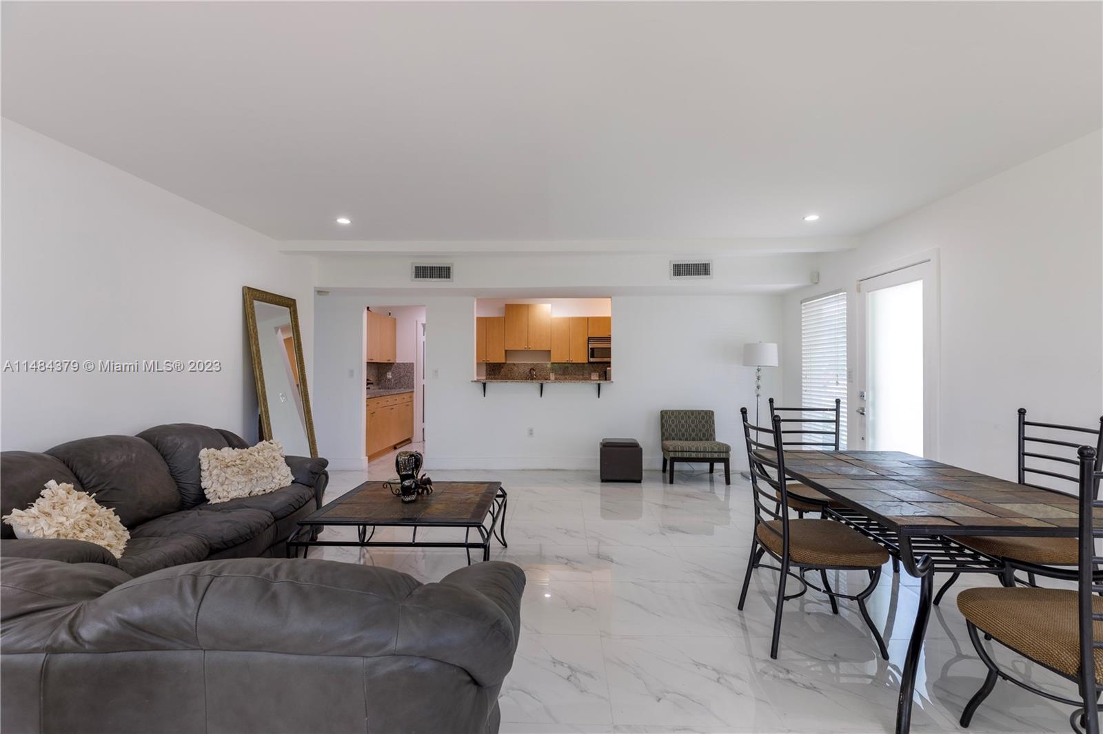 1990 Keystone Boulevard North Miami, FL 33181 - Photo 6 of 20 a living room with furniture and a flat screen tv