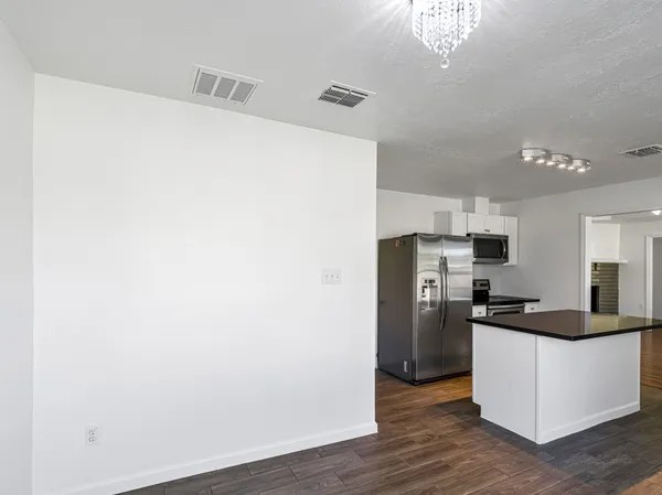 a kitchen with a refrigerator and cabinets