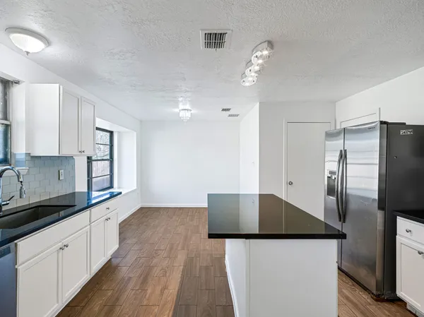 a kitchen with stainless steel appliances kitchen island a refrigerator sink and stove