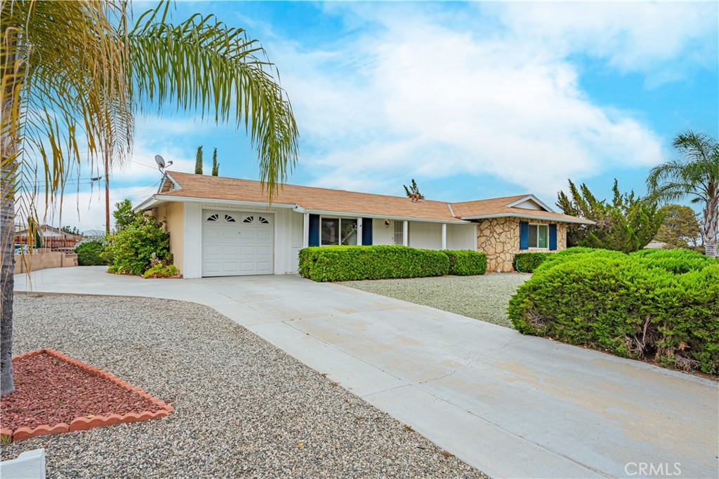 28450 West Worcester Road Menifee, CA 92586 - Photo 1 of 1 a front view of a house with a garden