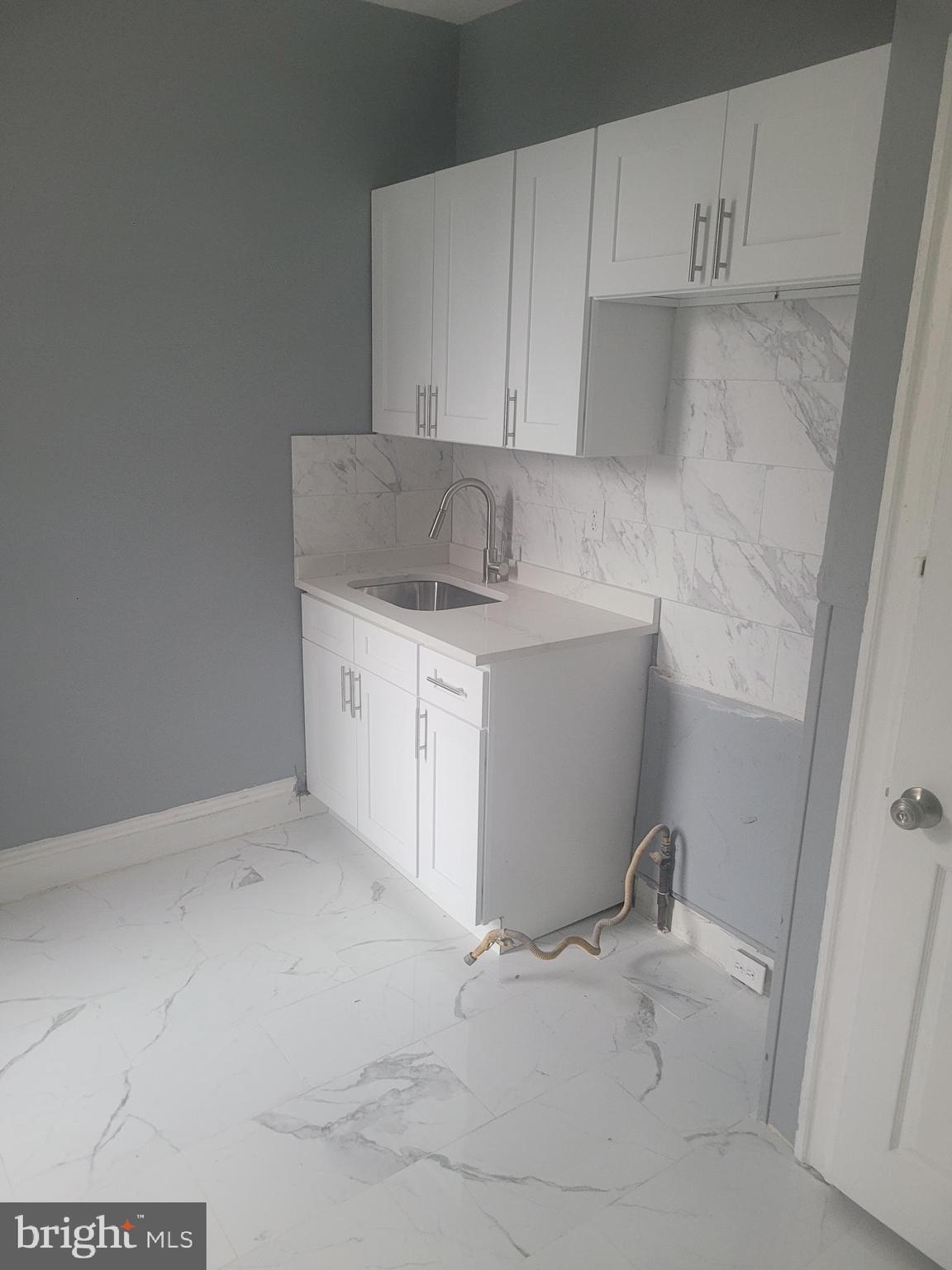 134 North Ruby Street, Unit 2 Philadelphia, PA 19139 - Photo 14 of 16 a utility room with a sink