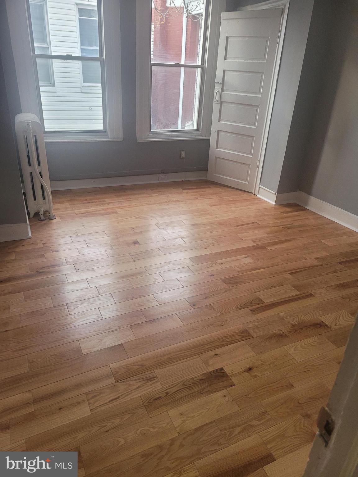 134 North Ruby Street, Unit 2 Philadelphia, PA 19139 - Photo 16 of 16 an empty room with wooden floor and windows