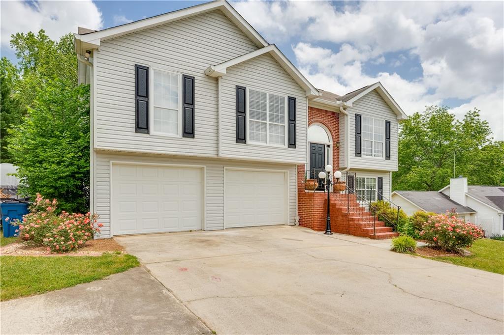 a front view of a house with a yard and garage