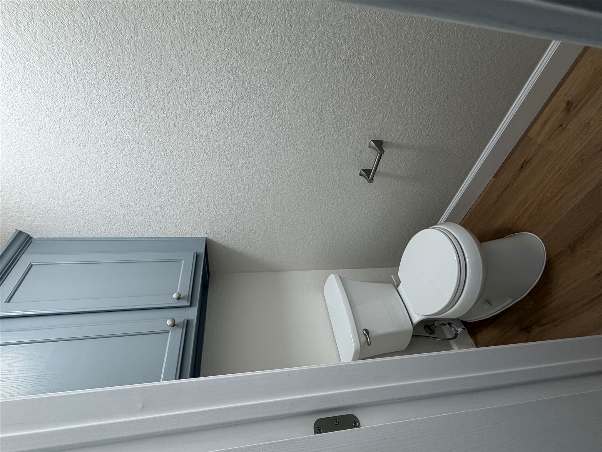 4604 Ramies Run Austin, TX 78749 - Photo 23 of 38 A functional half bath features classic wood flooring and built-in overhead cabinetry.