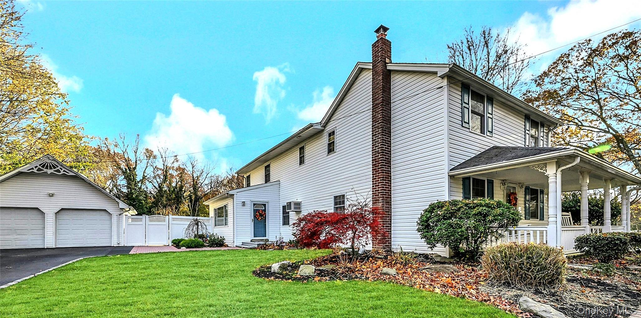 a view of house with a yard