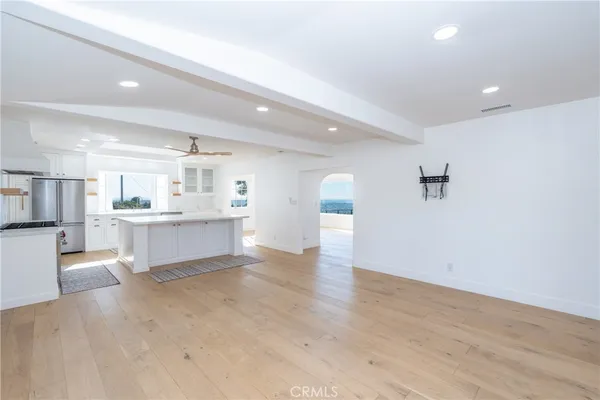 a view of an empty room with a fireplace and a window