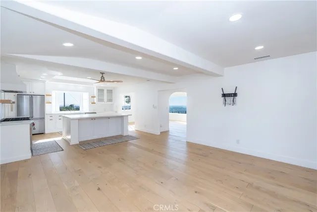 a view of an empty room with a fireplace and a window