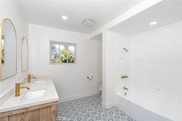 a bathroom with 2 sink and a mirror