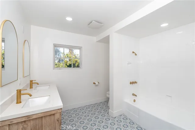 a bathroom with 2 sink and a mirror