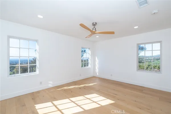 a view of storage and utility room with wooden floor