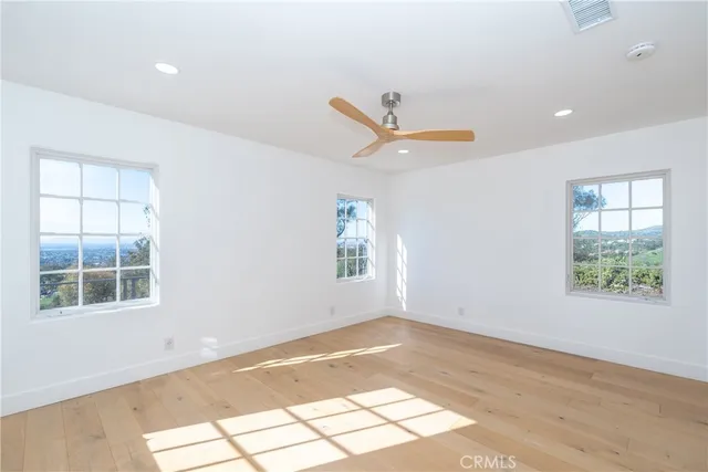a view of storage and utility room with wooden floor