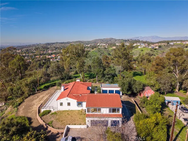 an aerial view of residential houses with city view