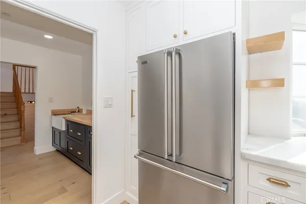 a kitchen with a stove a sink and a refrigerator