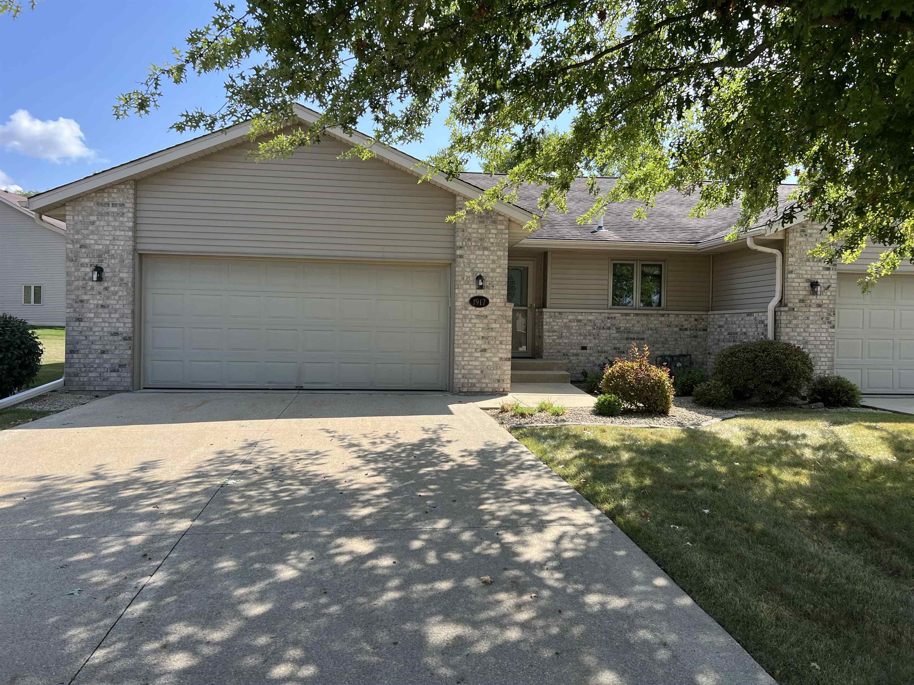 1917 Comanche Court Freeport, IL 61032 - Photo 1 of 25 a front view of a house with a yard and garage