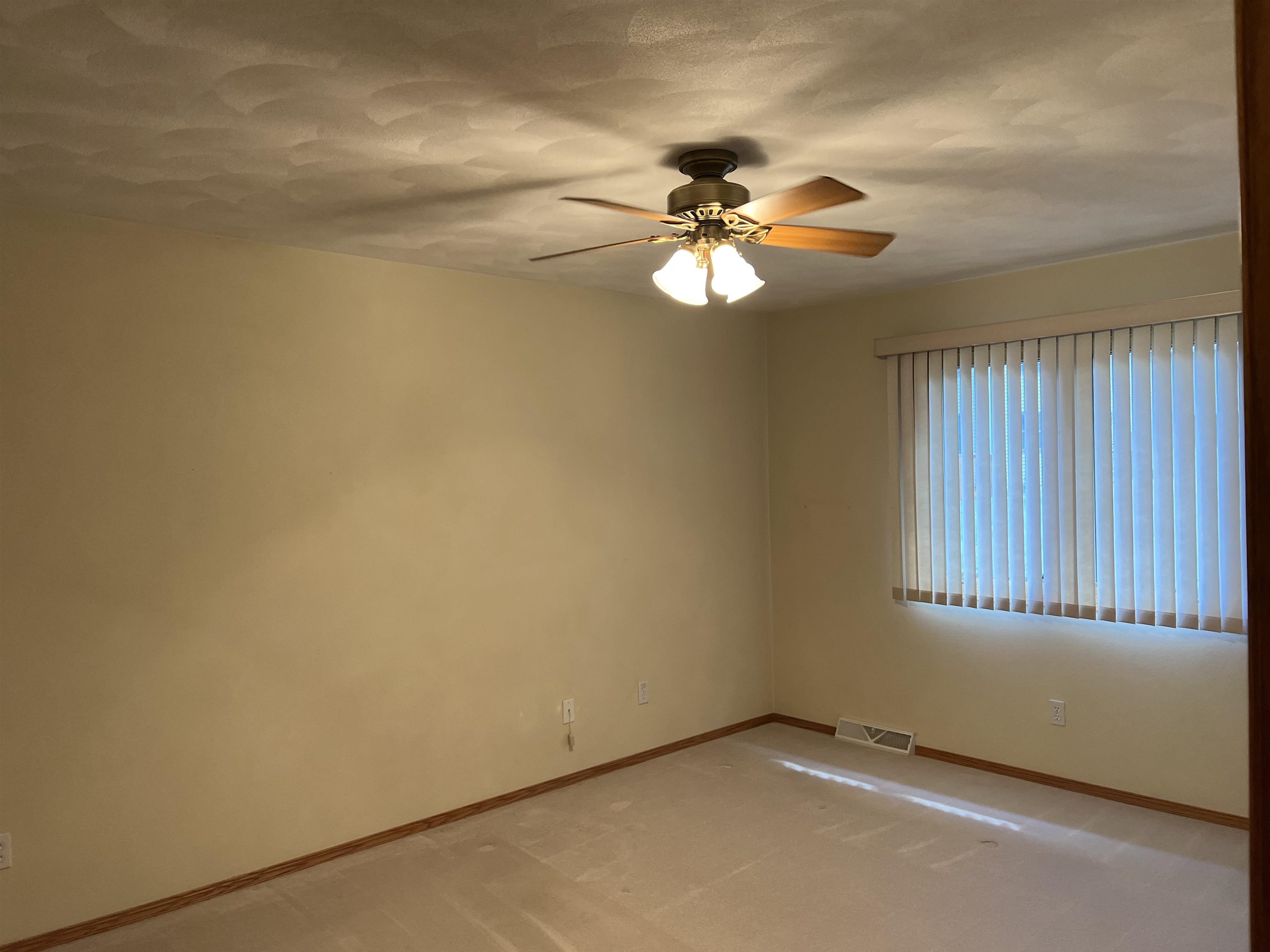1917 Comanche Court Freeport, IL 61032 - Photo 17 of 25 an empty room with windows and fan