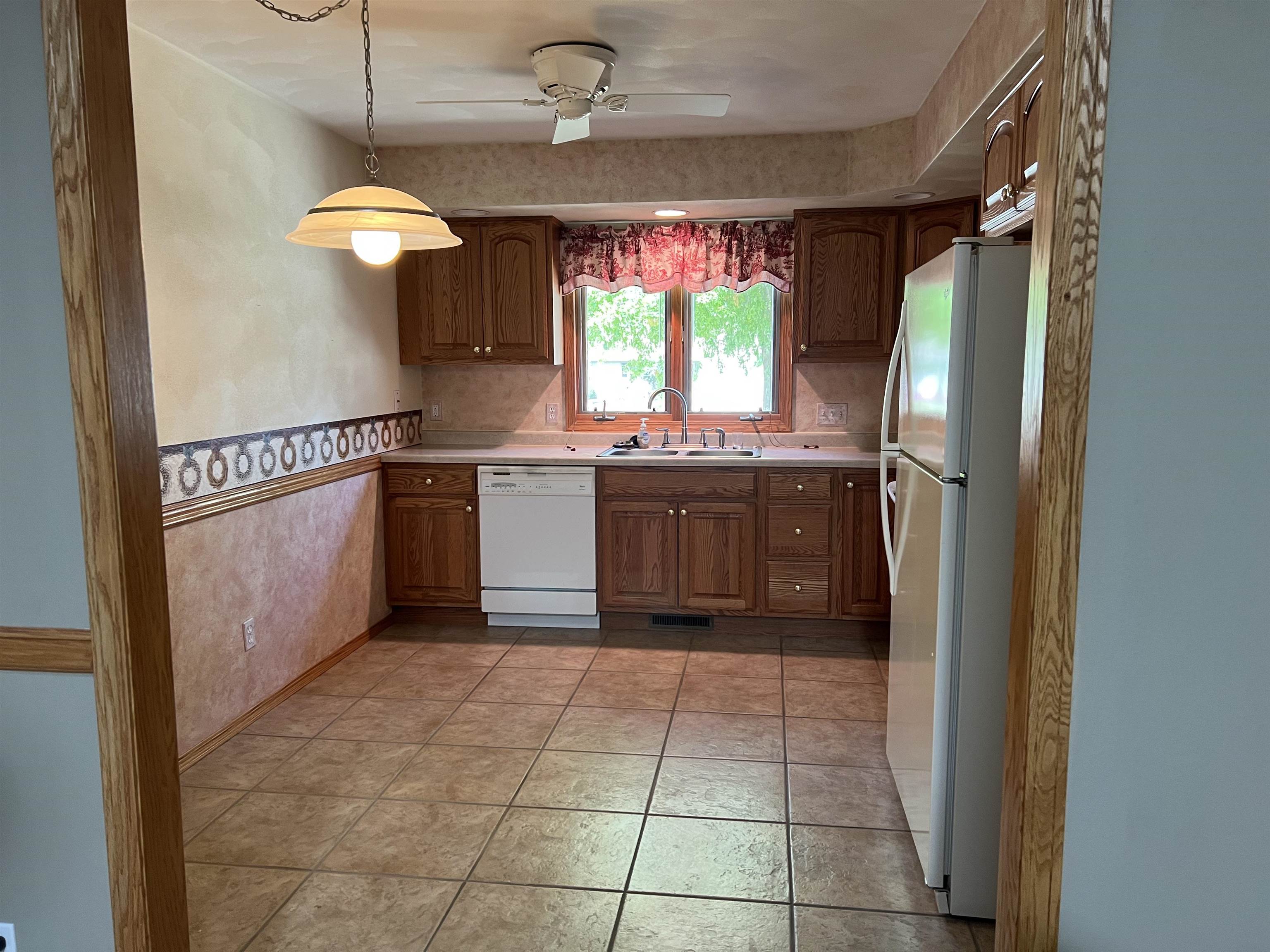 1917 Comanche Court Freeport, IL 61032 - Photo 6 of 25 a kitchen with stainless steel appliances granite countertop a refrigerator and a sink