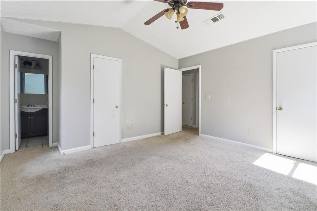 5288 Biffle Downs Road Stone Mountain, GA 30088 - Photo 12 of 18 an empty room with a ceiling fan and carpet