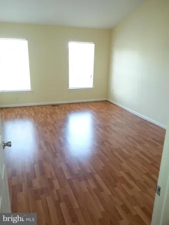 a view of an empty room and wooden floor