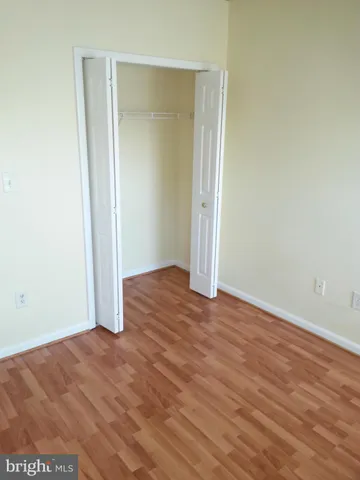 a view of hallway with wooden floor
