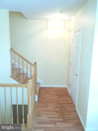 a view of a hallway with wooden floor and entryway