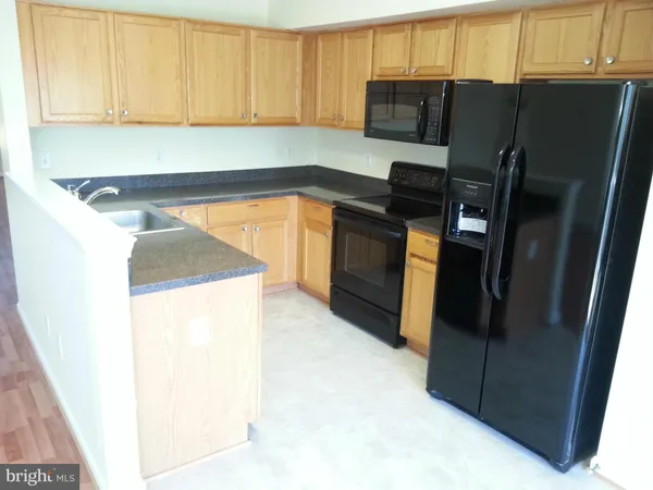 a kitchen with a refrigerator and a stove