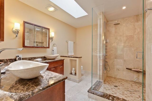 211 Washington Road Lake Forest, IL 60045 - Photo 12 of 26 a spacious bathroom with a granite countertop sink a mirror and a shower