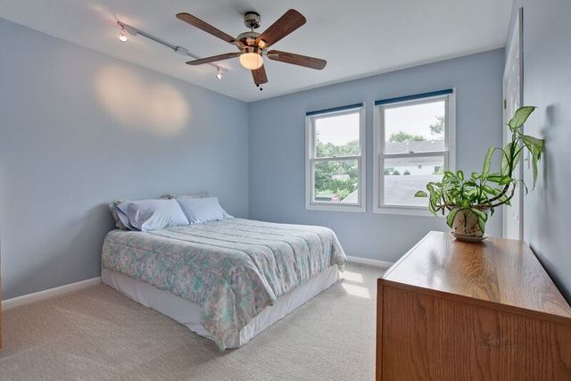 211 Washington Road Lake Forest, IL 60045 - Photo 14 of 26 a bedroom with a large bed and a potted plant