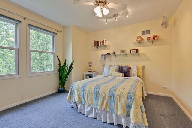 211 Washington Road Lake Forest, IL 60045 - Photo 15 of 26 a bedroom with a bed and a chandelier