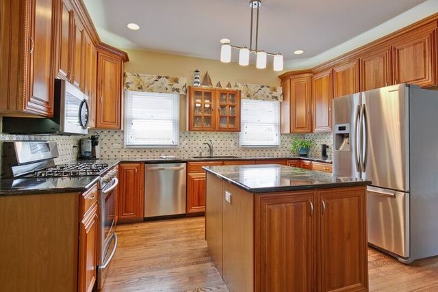 211 Washington Road Lake Forest, IL 60045 - Photo 5 of 26 a kitchen with stainless steel appliances granite countertop a refrigerator a sink dishwasher a stove and a oven with wooden floor